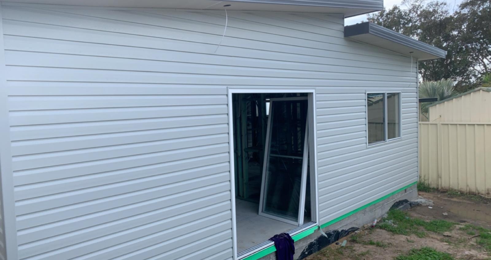 White weatherboard cladding — side elevation